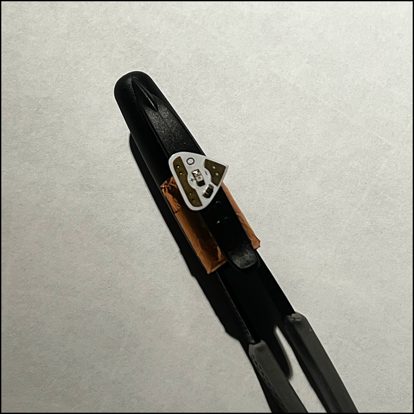 Light placed on the cap with the -ve and +ve sides flowing in the proper direction of current flow.